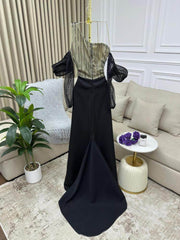 فستان سهرة أسود ملكي بلمسة شفافة وأناقة عصرية